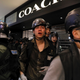 An injured policeman is escorted by his colleague after scuffles with protesters inside a mall in Sha Tin in Hong Kong, July 14, 2019.